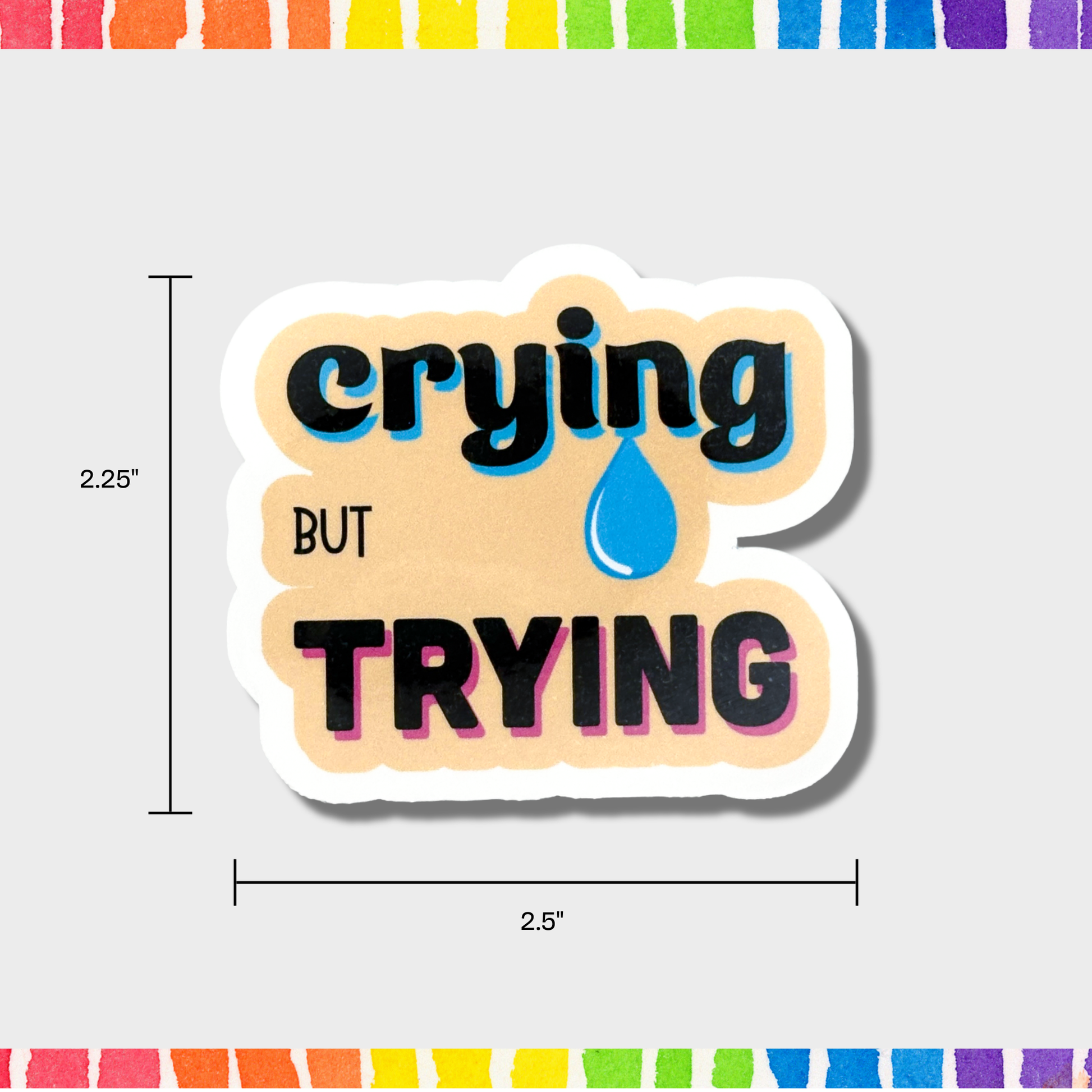Sticker with 'crying but trying' text and measurements of 2.25"x2.5" on a white background 