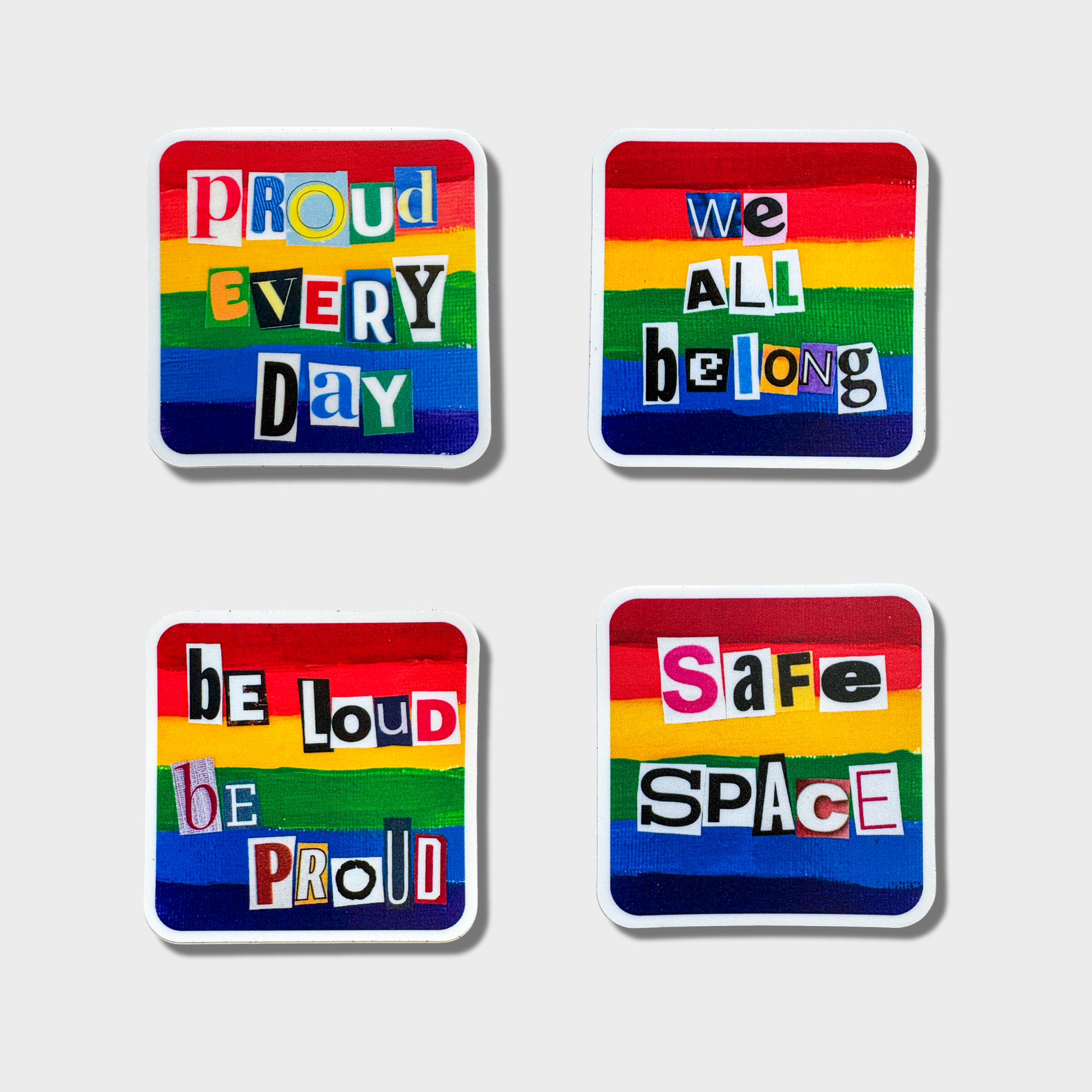 Four rainbow-colored stickers with motivational phrases on a white background