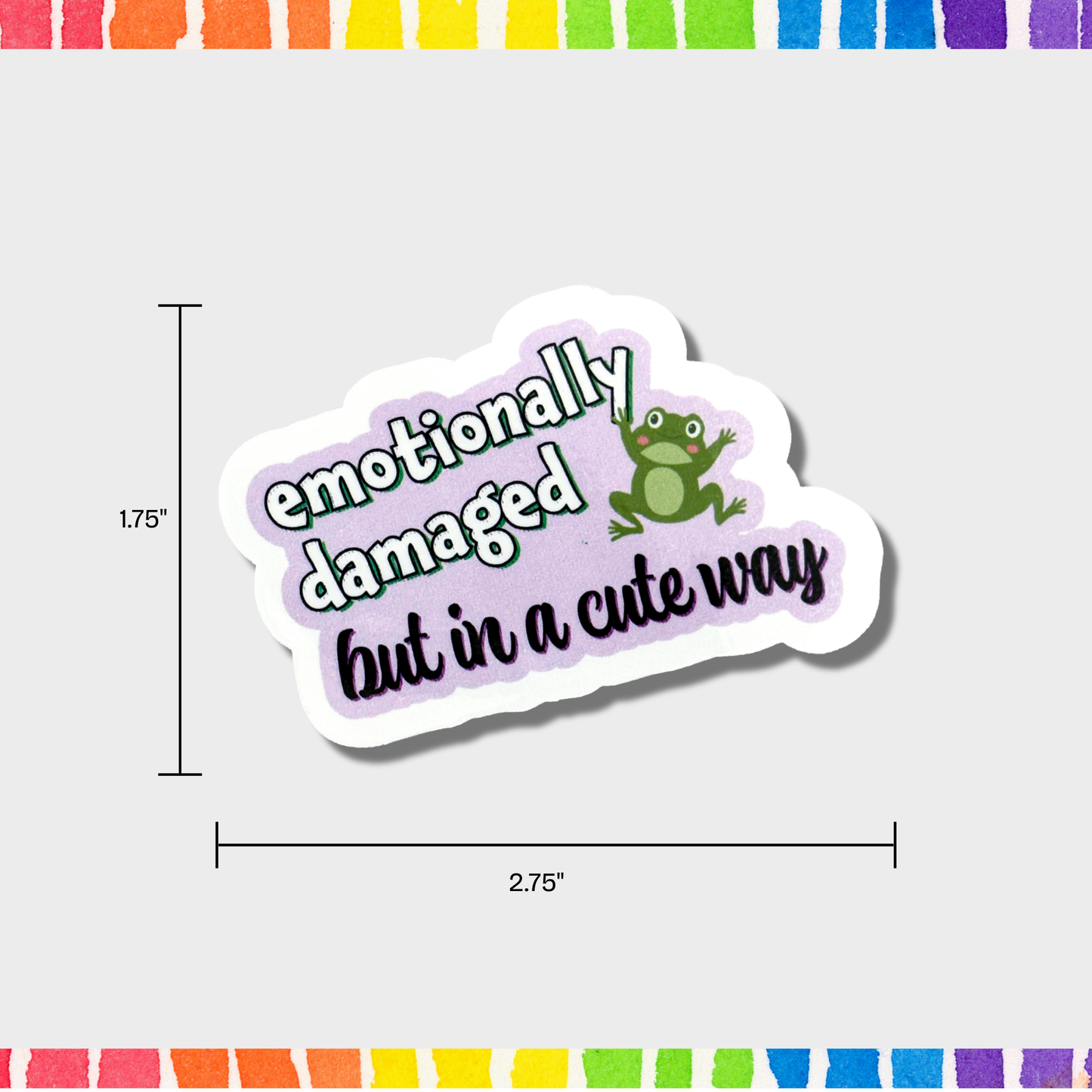 Sticker with text 'emotionally damaged but in a cute way' and a frog graphic, with dimensions 1.75"x2.75" displayed.