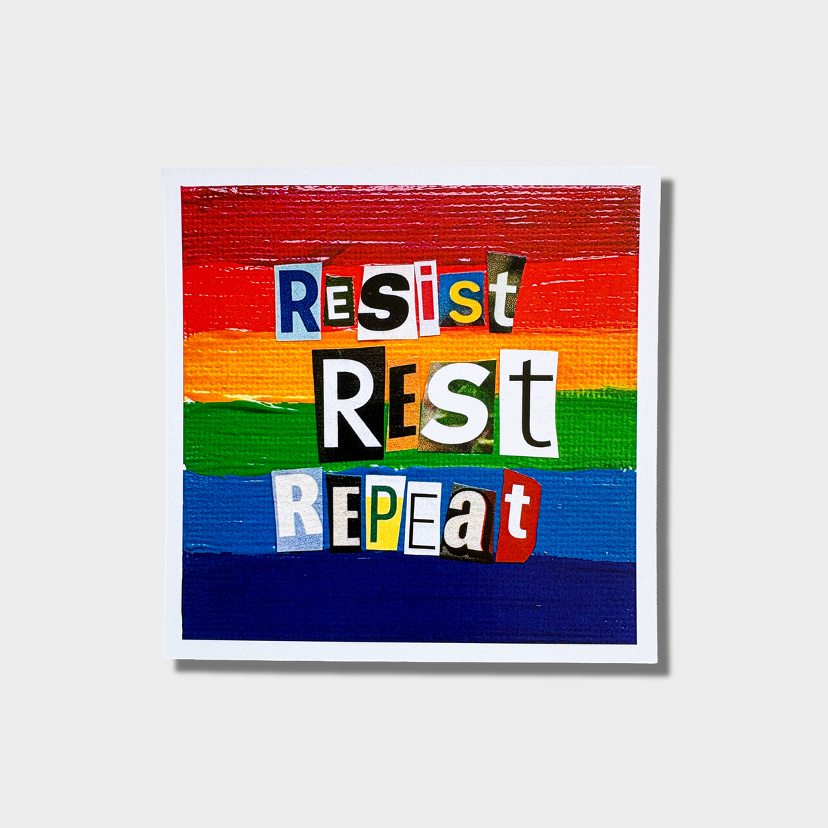 6" x 6" Art Print with a vibrant rainbow background showing the hand-painted look of canvas with the phrase Resist Rest Repeat in bold collage style letters. 