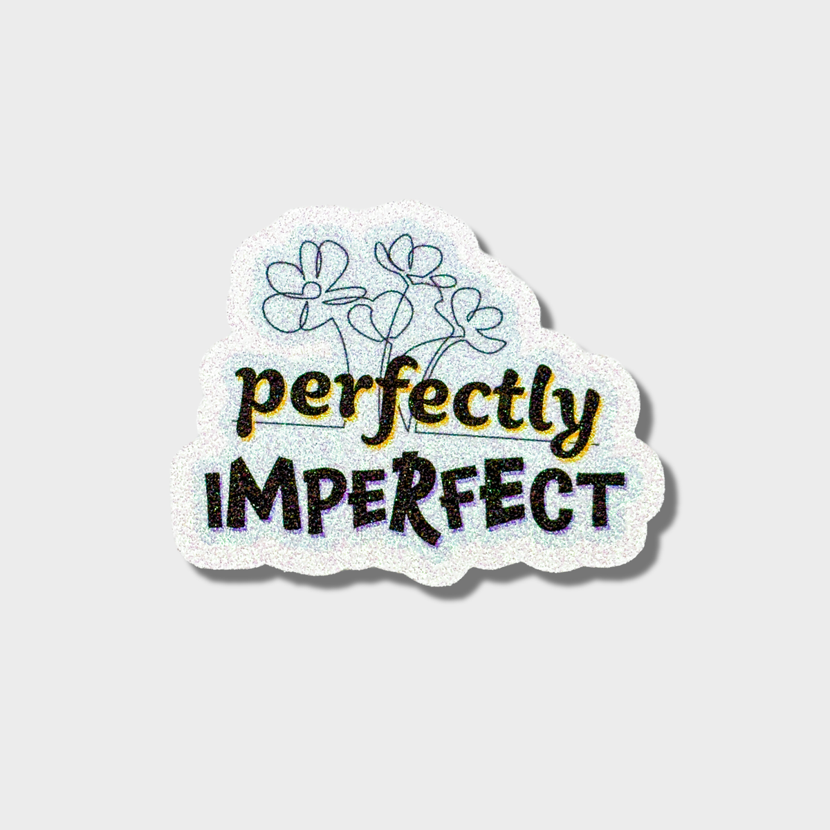 Glitter sticker with 'perfectly imperfect' text on a light blue background with a fine line floral design