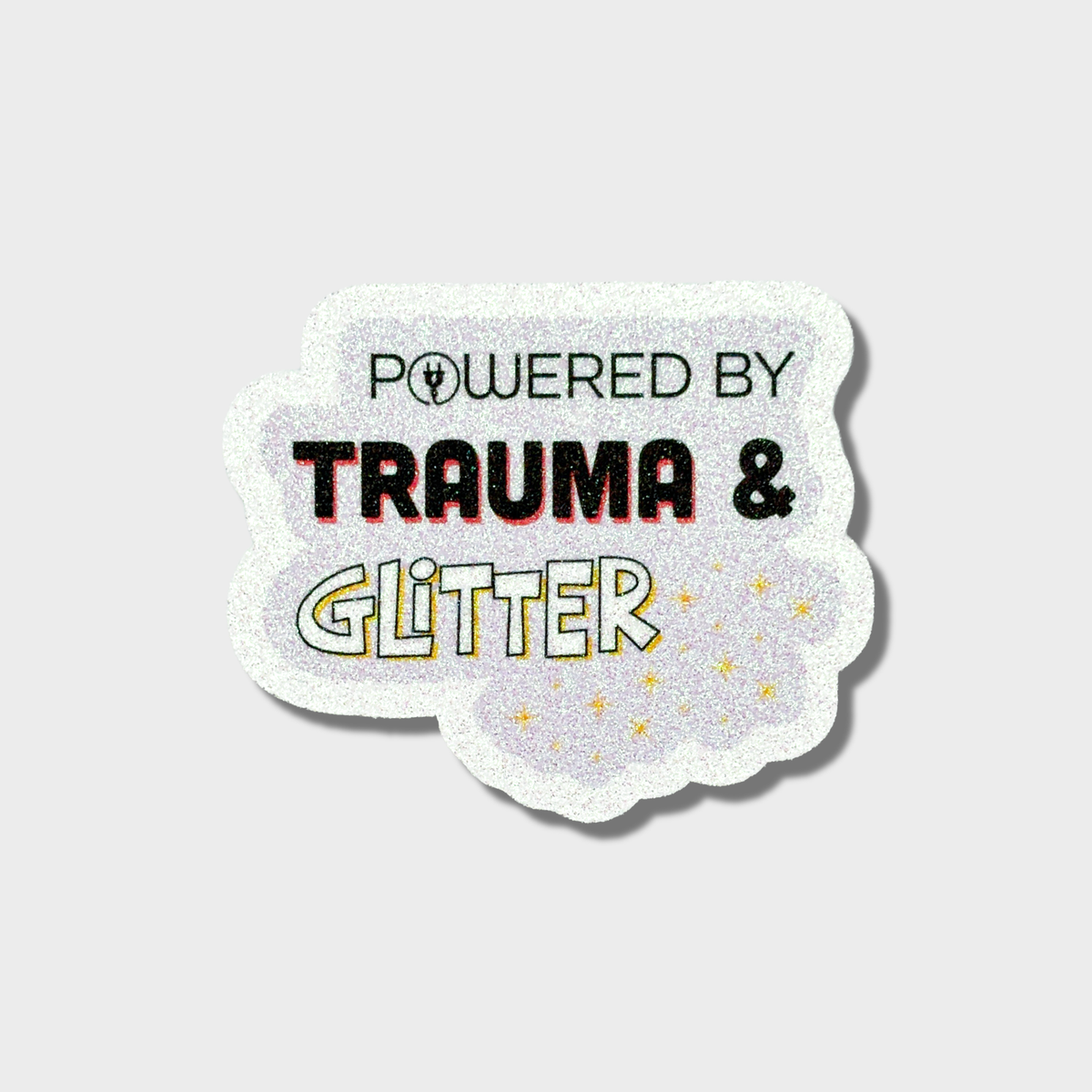 Sticker with 'Powered by Trauma & Glitter' text on a light purple background
